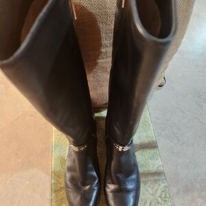Michael Kors tall, black riding boots with harness, silver detail. 100% leather.